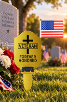 Gold metal Veteran Grave Marker with solar light and American flag displayed at a cemetery